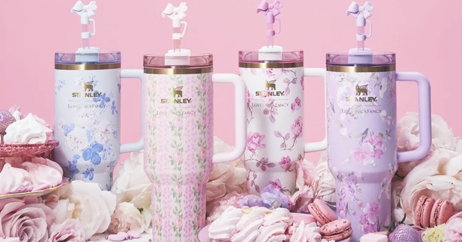 four stanley tumblers in pastel floral prints with bow straw toppers