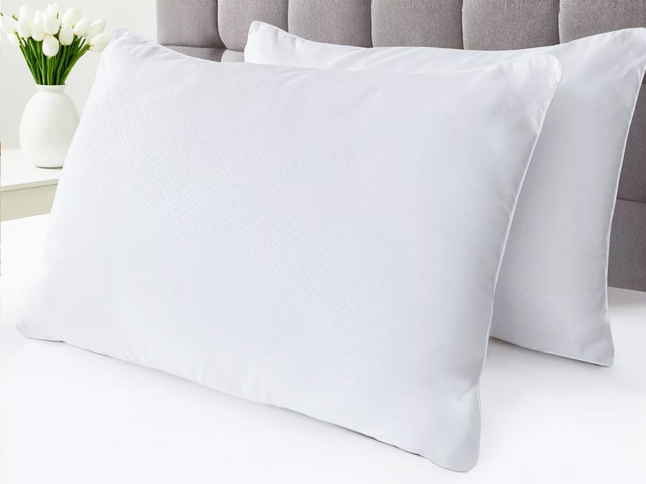 two white pillows on a bed
