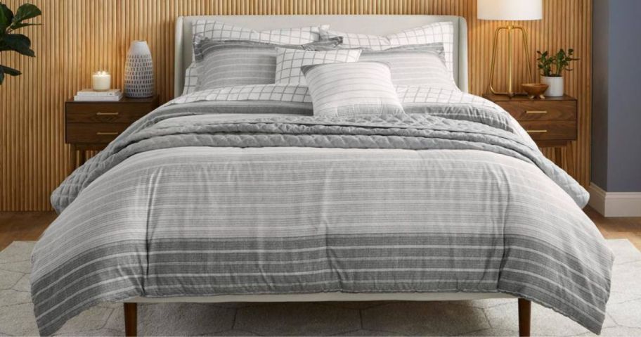 A bed with a striped comforter
