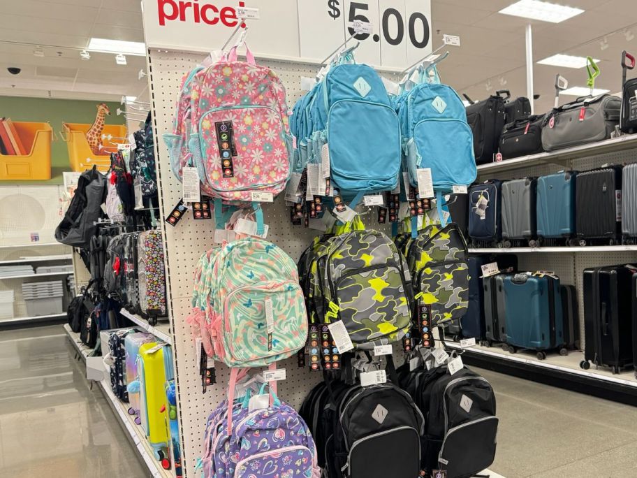 a number of backpacks on an end cap at Target