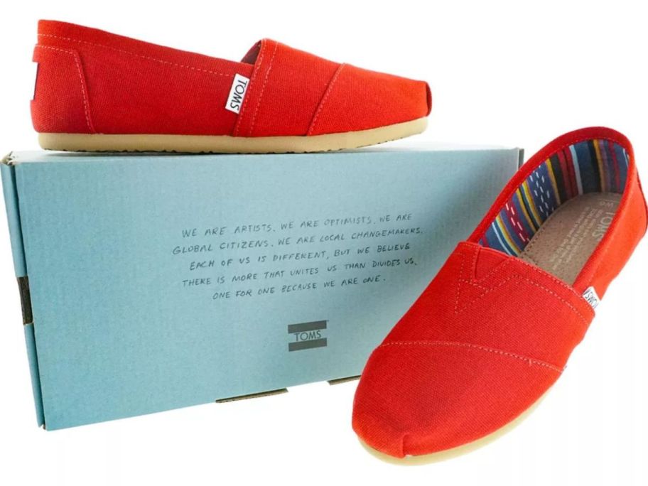  pair of red Tom's shoes and a blue box