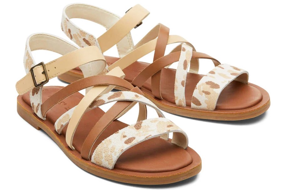 pair of brown and tan cow print sandals