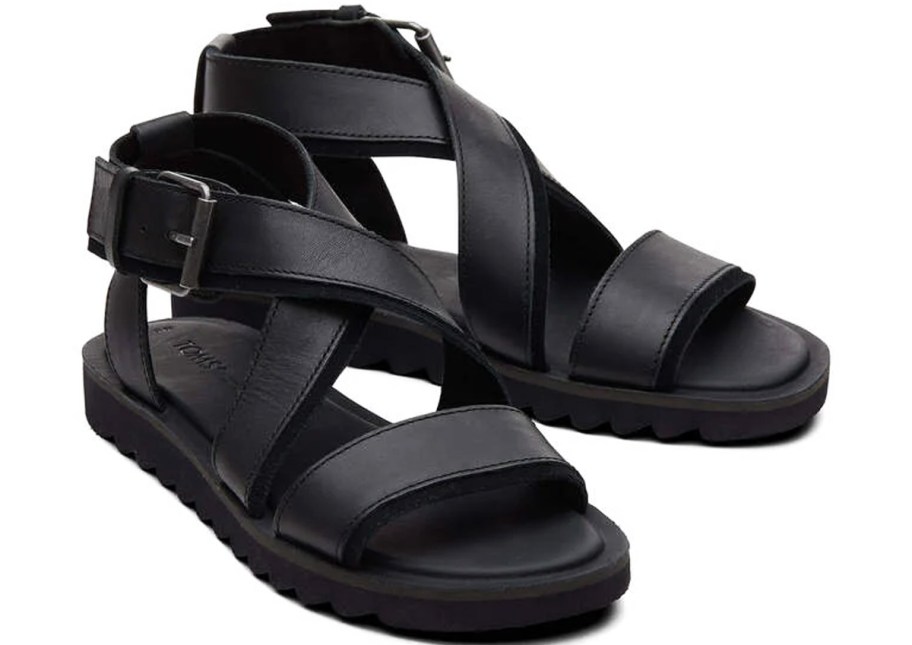 pair of black sandals with crisscross ankle straps