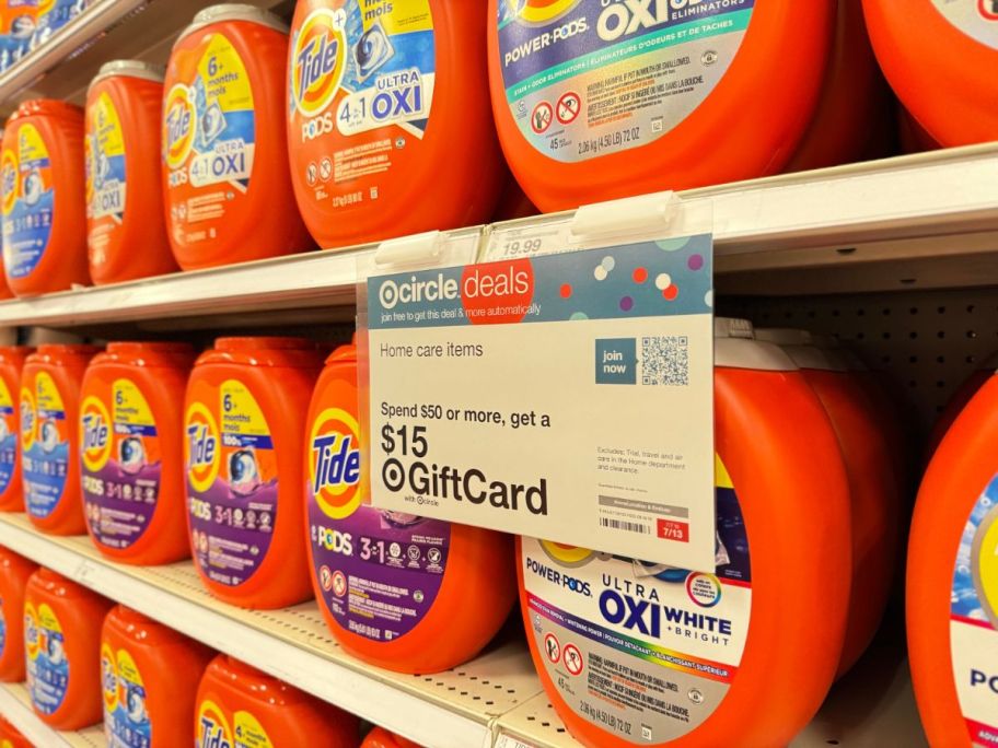Shelf of Tide pods with free $15 Gift Card with $50 purchase sign at Target