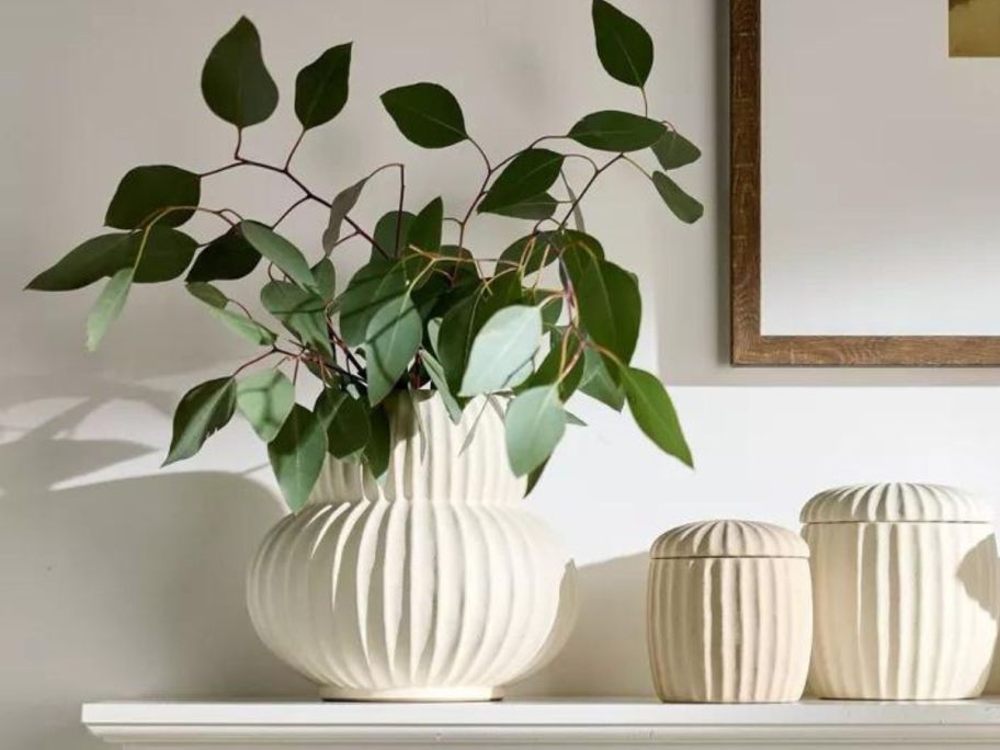 Threshold Designed w/ Studio McGee Ceramic Sandy Glaze Vase on mantle with leafy stems in it