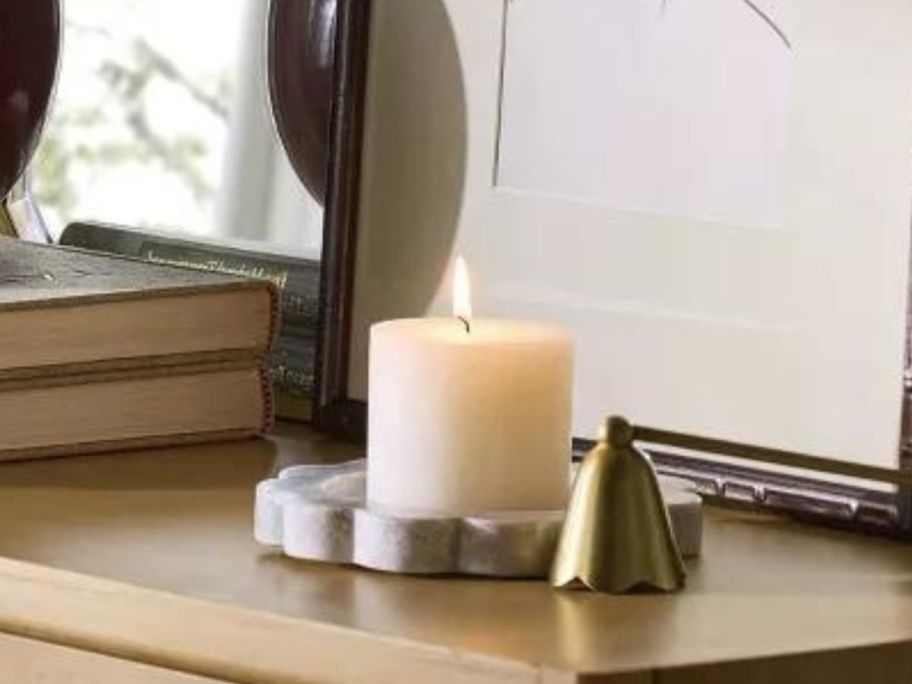 Threshold Designed w/ Studio McGee Gray Marble Candle Tray on table with lit candle on it