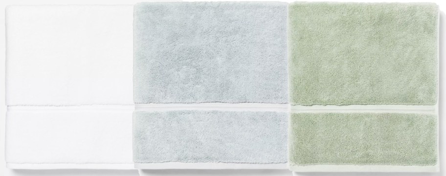 white, light blue, and light green bath towels