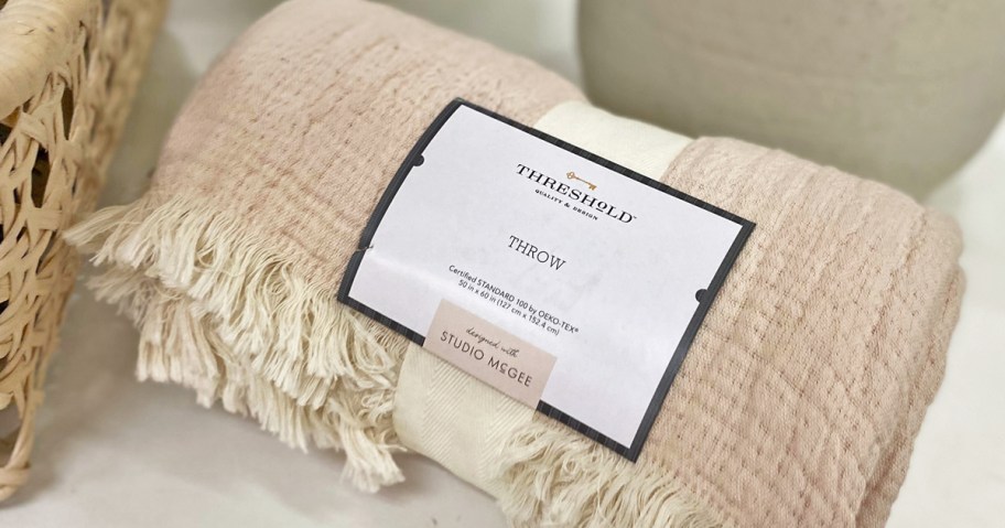 rolled throw blanket on a store shelf