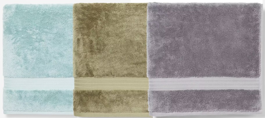 light blue, green, and grey bath towels