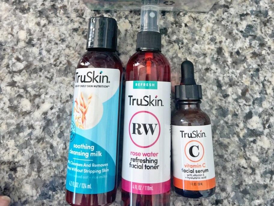 truskin cleanser, rose water mist, and vitamin c serum on counter