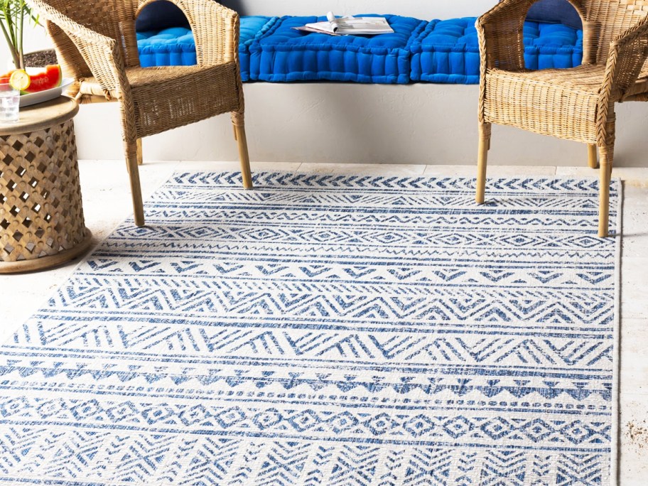 patio chairs on blue and white geometric print rug