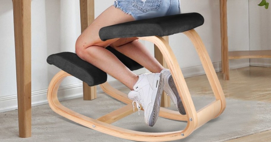 woman sitting on a wooden ergonomic kneeling chair