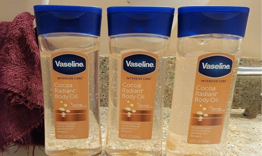 3 bottles of body oil gel on a bathroom counter