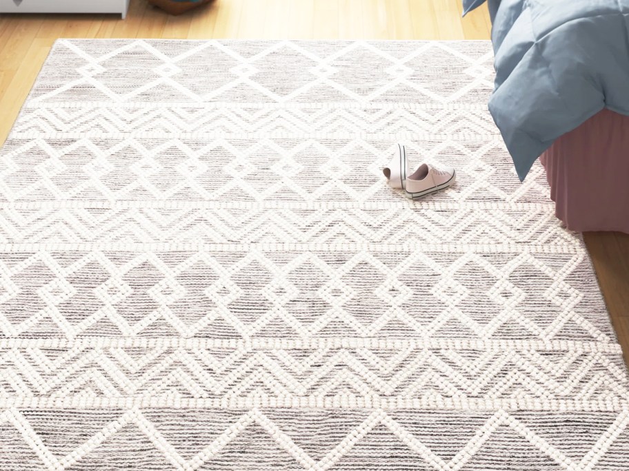 geometric print rug next to bed