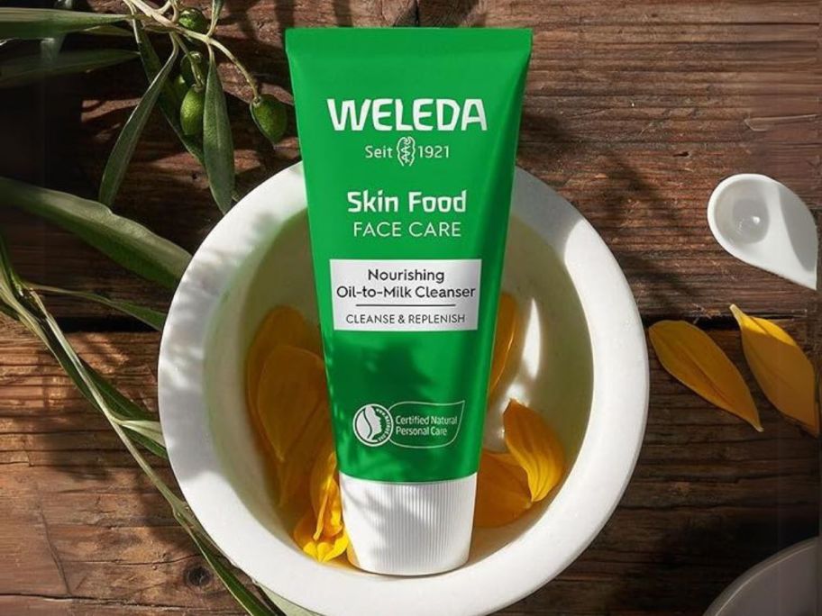 Weleda Skin Food Face Care Nourishing Oil-to-Milk Cleanser 2.5oz bottle in bowl