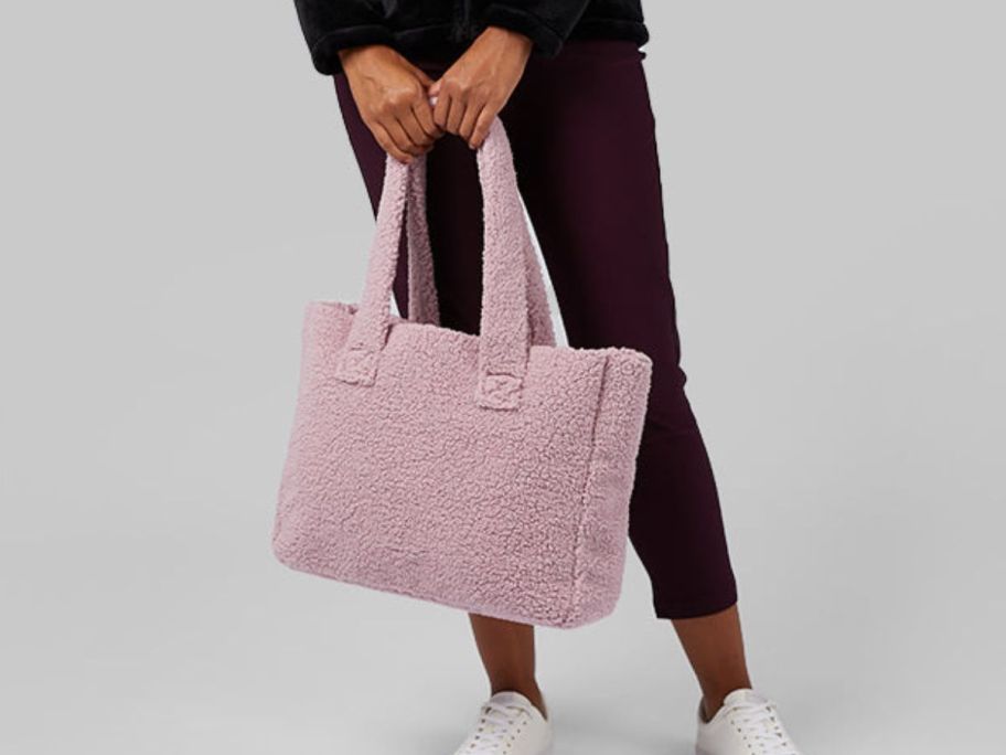 Woman holding sherpa purse in pink