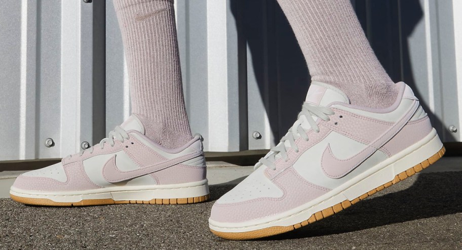 Women pink dunks displayed while walking