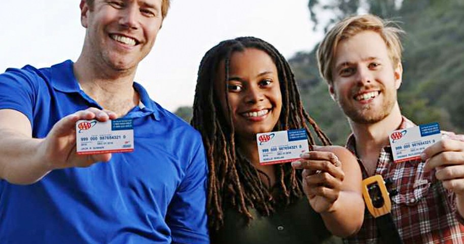 three people holding up aaa membership cards 