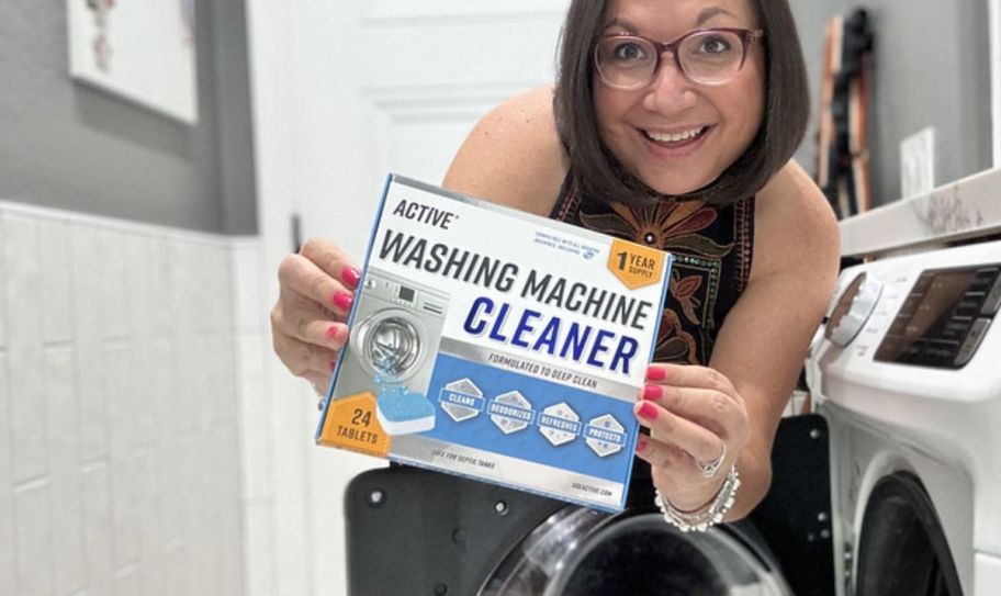 a womans holding a box of Active Wadshing Maachine Cleaner and smiling