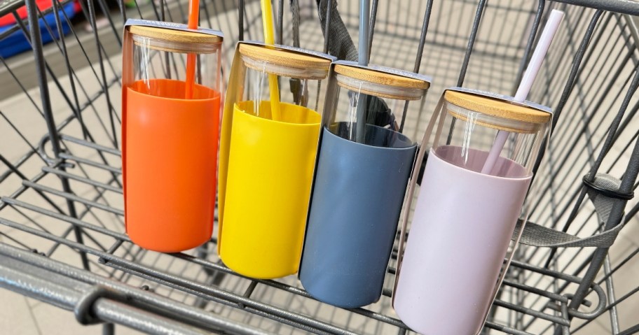 4 glass tumblers with bamboo lids and different color silicone wrap sleeves and straws in a shopping cart