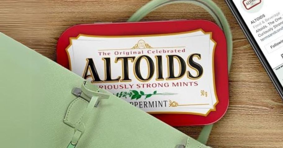 Altoids Peppermint Mint 1.76oz in a purse on table