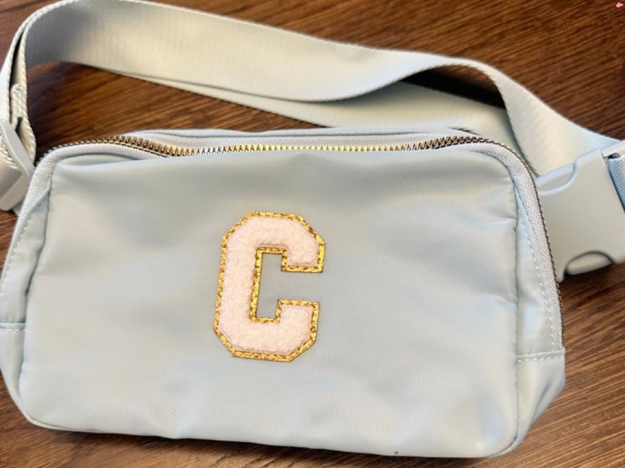 Letter C blue belt bag laying on table