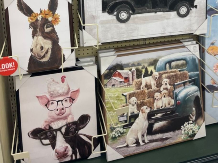 donkey, pig and cow, and puppy wall art hanging in store