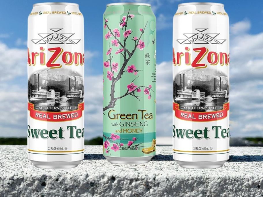 arizona tea cans on concrete ledge against blue sky