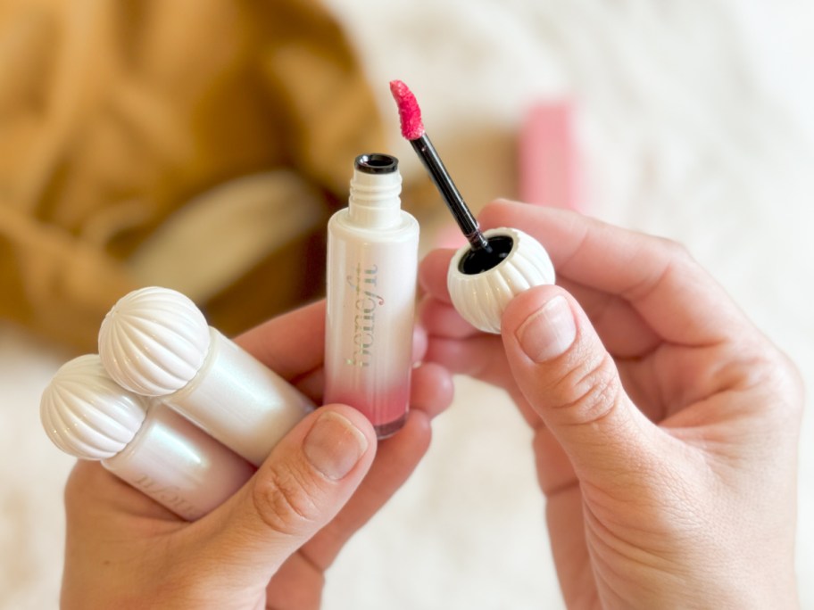 hand holding lip color tubes