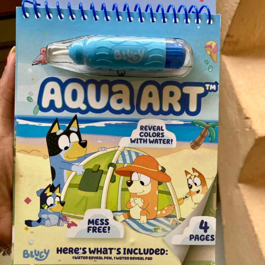 holding a Bluey Aqua Art activity pad