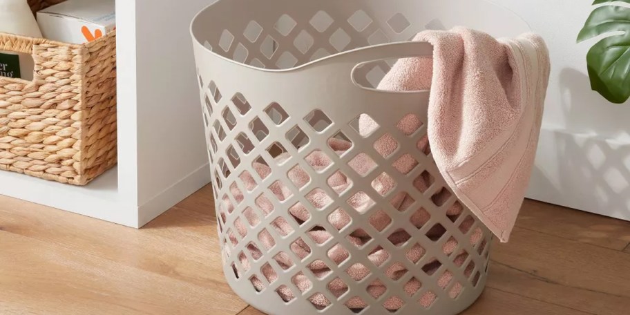 gray hamper with pink towels 