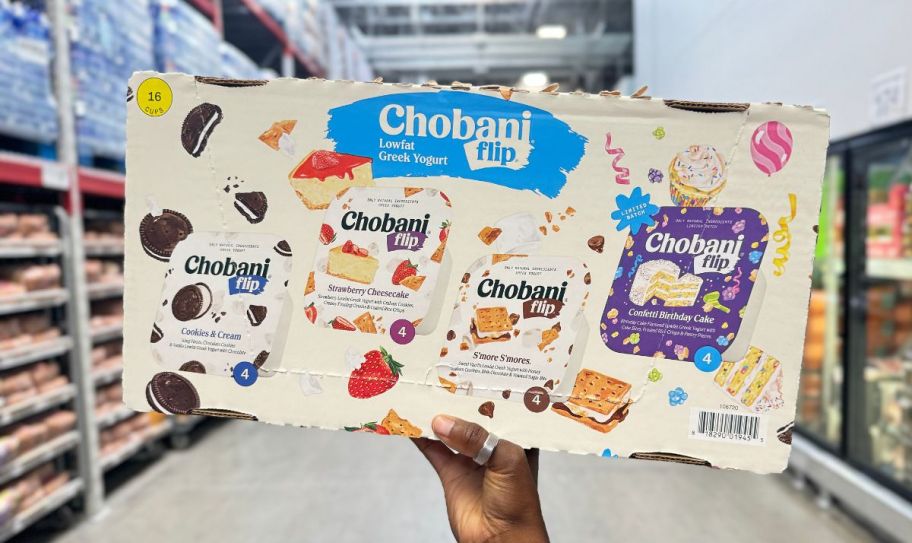 a womans hand holding a 16count pack of chobani flip greek yougurts