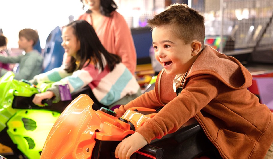 child on a ride at chuck e cheese