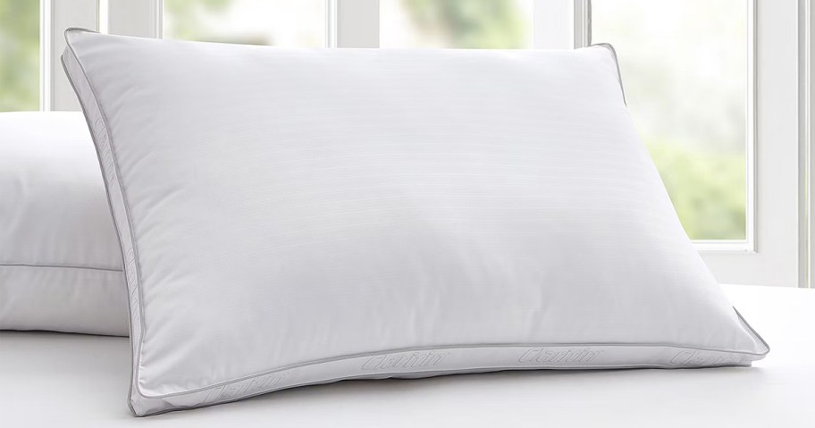white claritin allergy pillow on bed 
