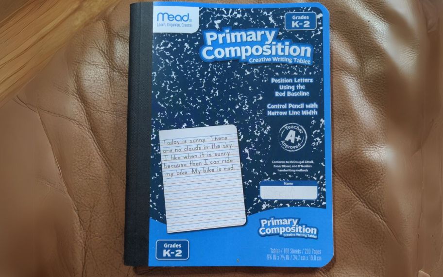 a composition notebook on a leather sofa