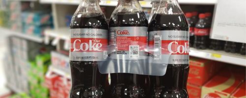 a mans hand holding a 6 pack of diet coke