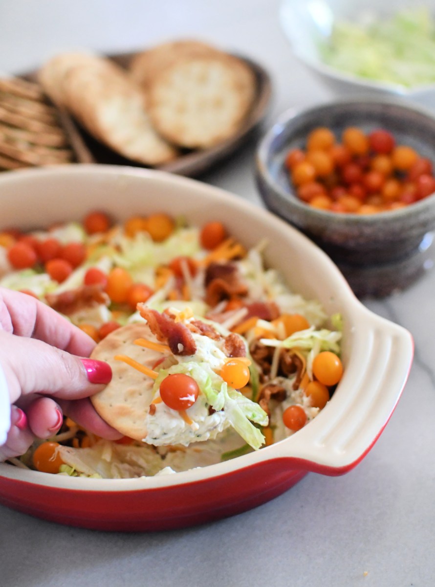 dipping a cracker in blt dip