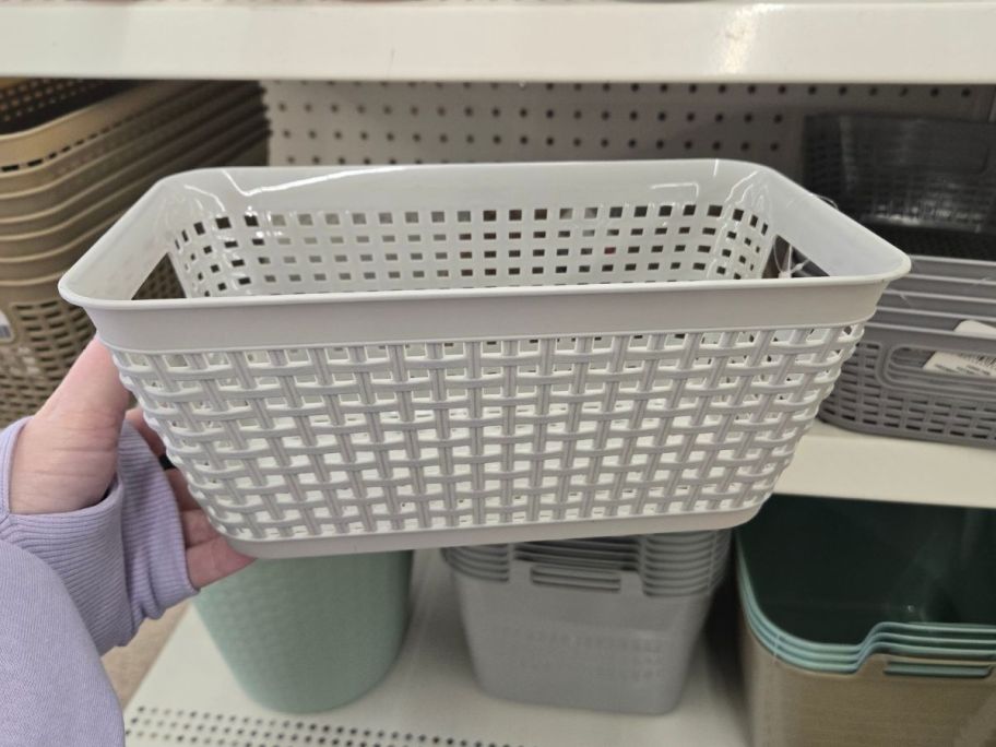 Essentials Plastic Woven-Looking Storage Basket in hand in store