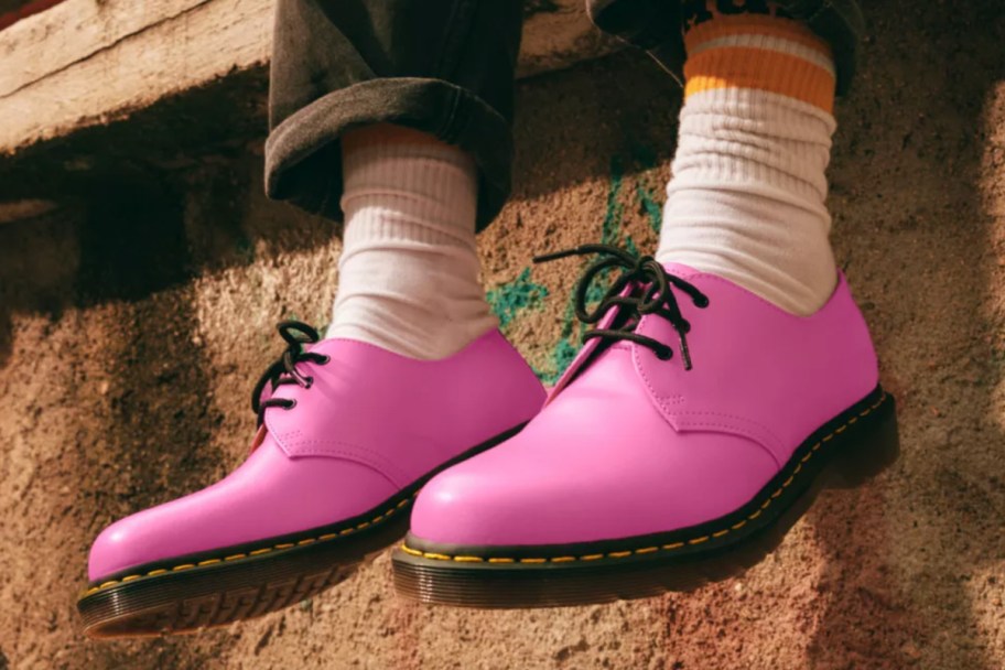 pink oxfords on feet hanging off edge