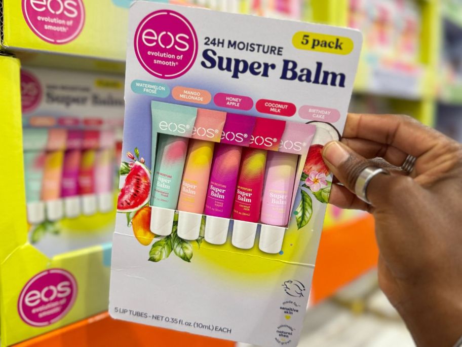 hand holding eos Super Balm 5-Tube Pack in store