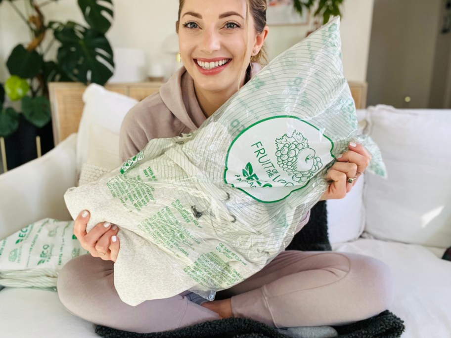 Sarah holding a Fruit of the Loom package