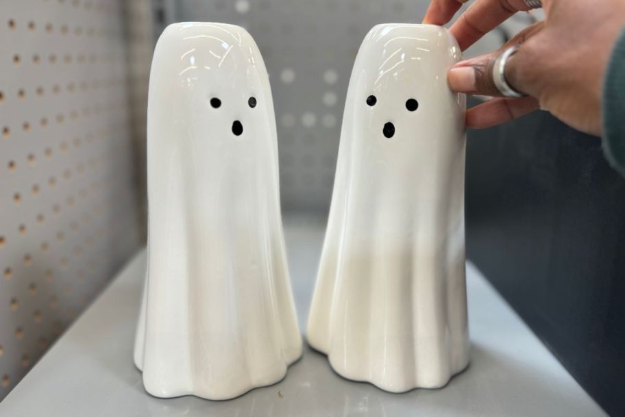 two white ghost figurines on a store shelf