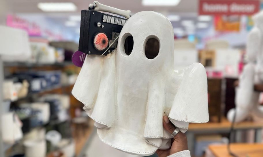 a wooden ghost figure with boom box