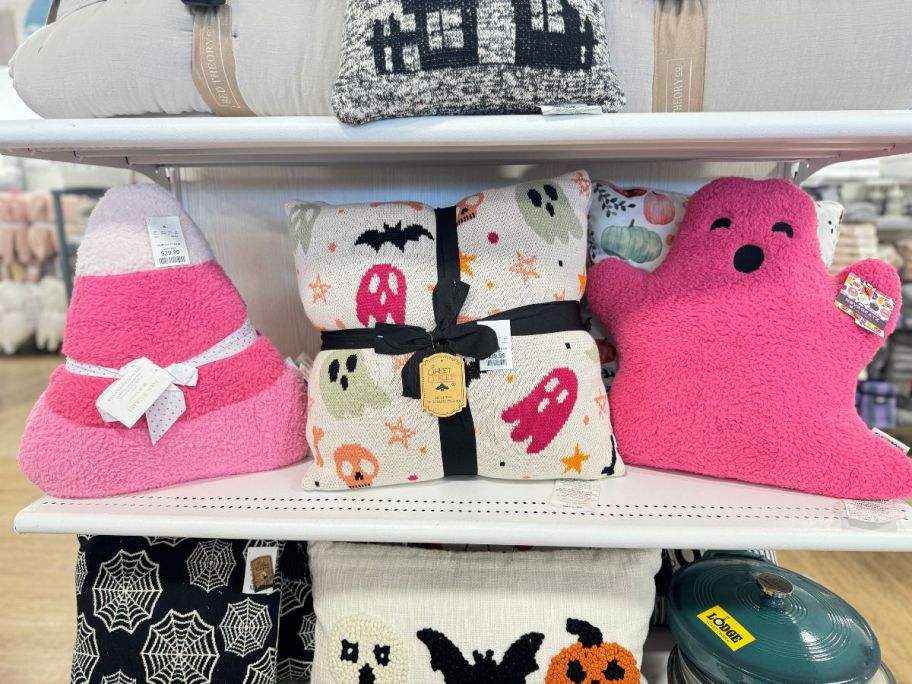 3 decorative pillows on a store shelf
