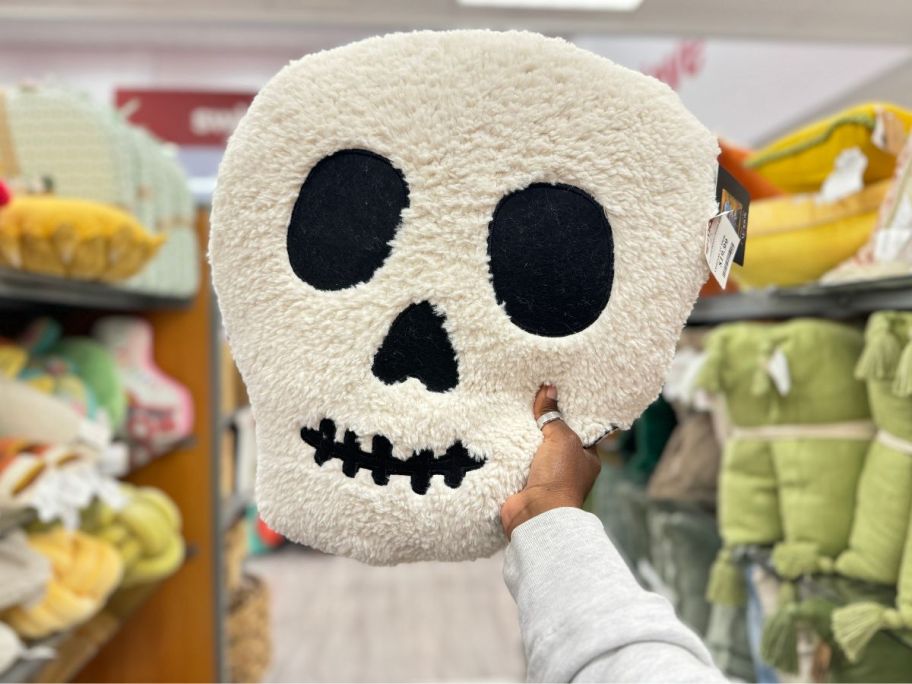 a skull-shaped plush pillow