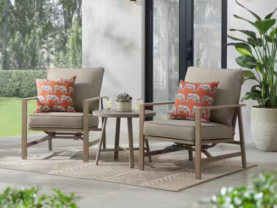 tan chairs and matching table on patio 