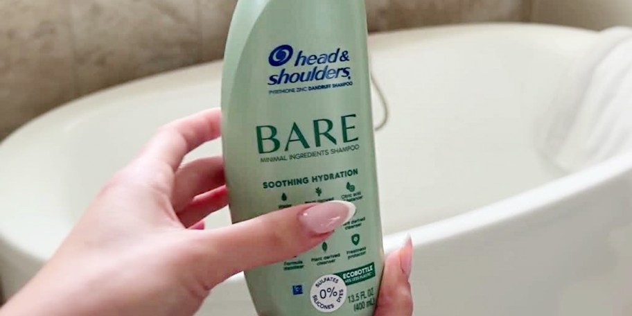 hand holding head and shoulders bare shampoo
