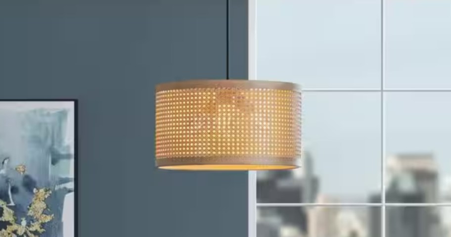 round tan rattan pendant light fixture in a dining room