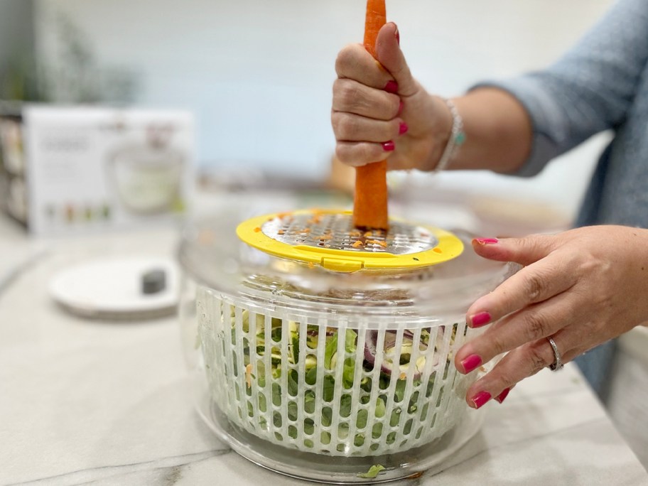 person cutting carrot on salad prep kit 