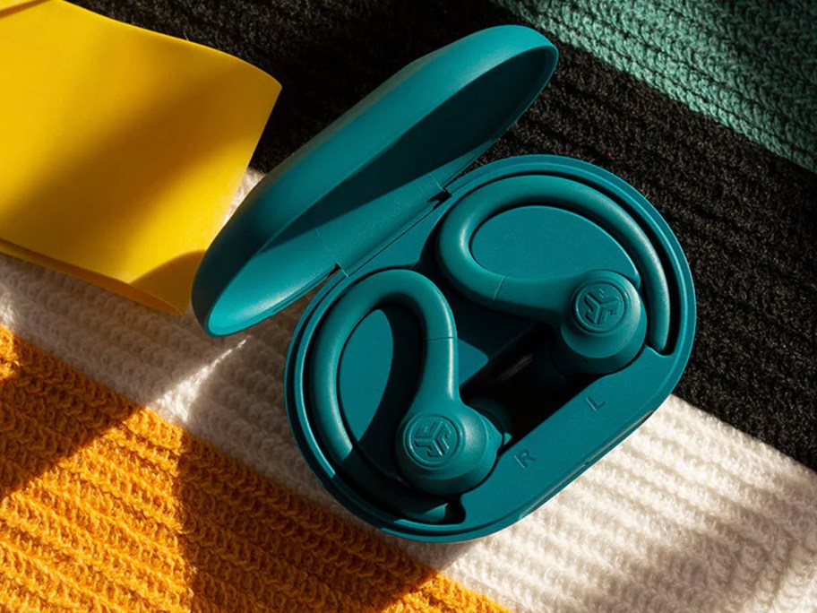 teal over ear earbuds in case on table